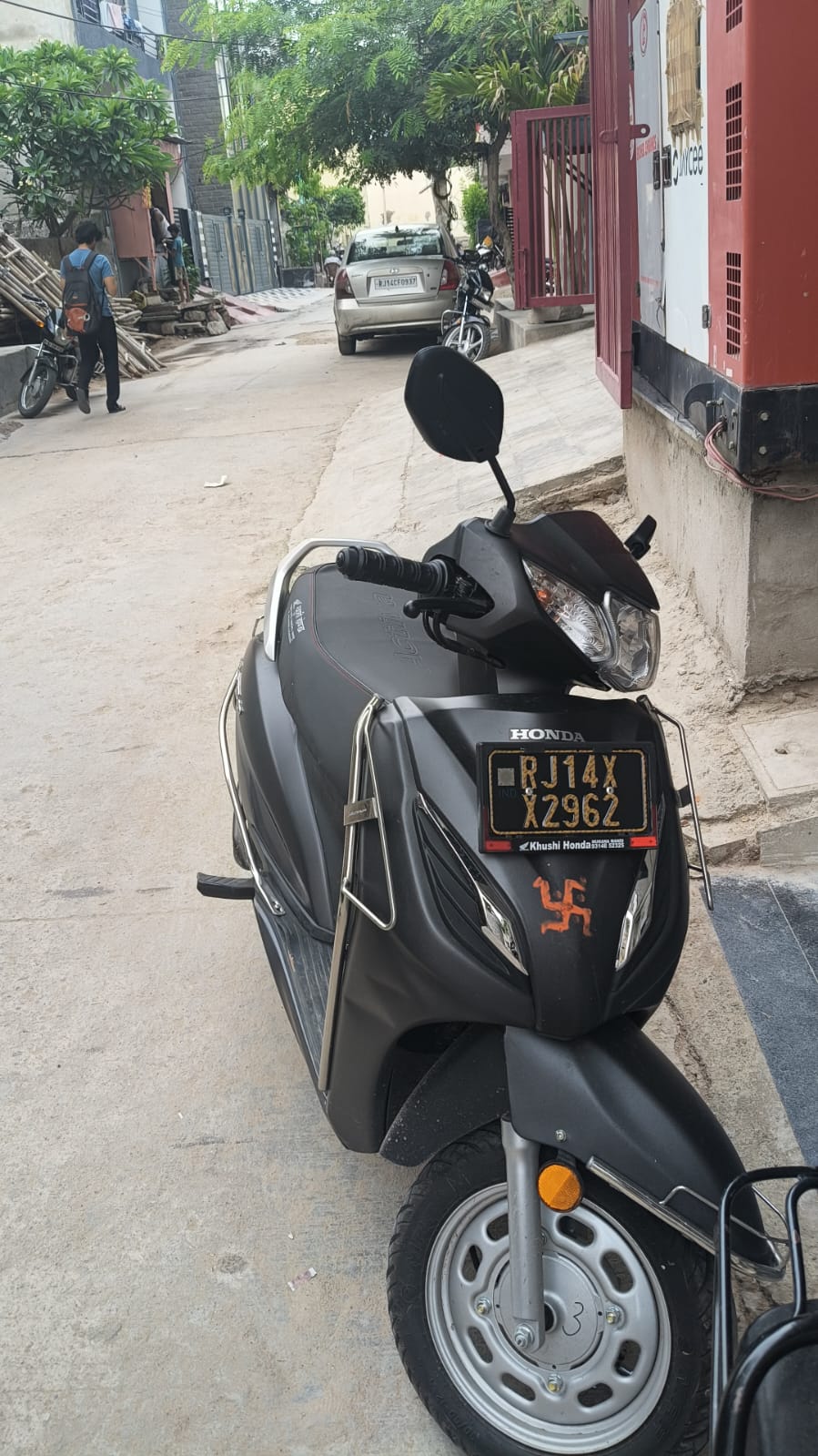 Black Honda Activa scooter parked and ready for rental
