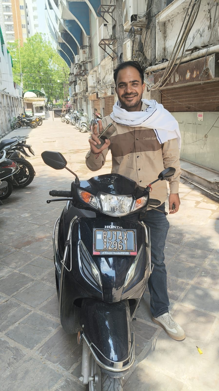 Customer receiving a black Honda Activa scooter rental